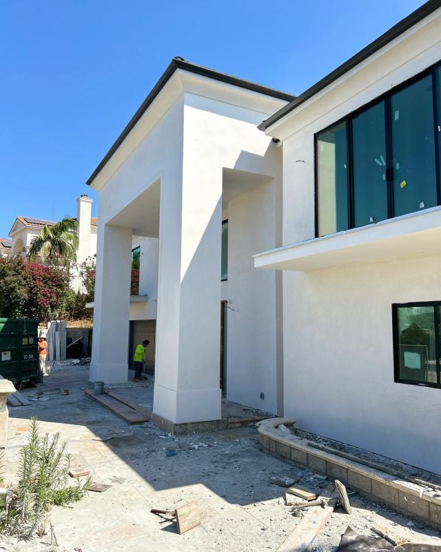 Smooth stucco at a grand two-story entry