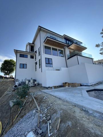 Modern three-story build, stucco complete before landscaping