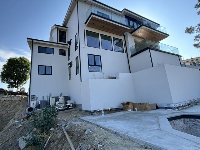 Modern three-story build, stucco complete before landscaping