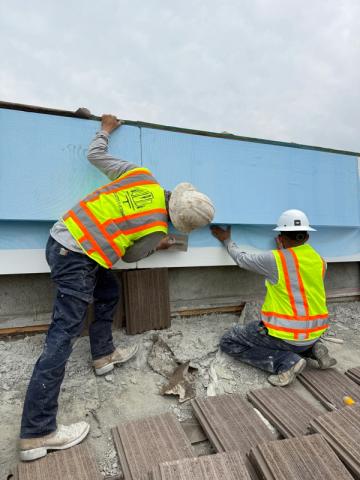 Crew setting a foam parapet cap — Duarte's Plastering project near Fullerton, CA