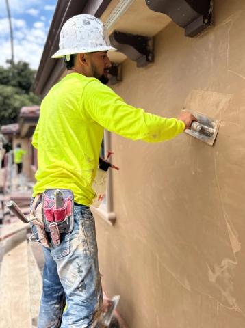 Plasterer troweling a finish coat — Duarte's Plastering project near Garden Grove, CA
