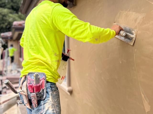 Plasterer troweling a finish coat — Duarte's Plastering project near Garden Grove, CA