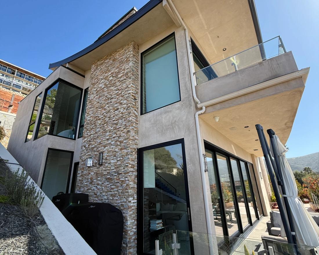 Finished smooth-troweled exterior with stacked stone — Duarte's Plastering project near Costa Mesa, CA