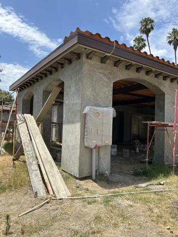 New construction, arched entry in brown coat