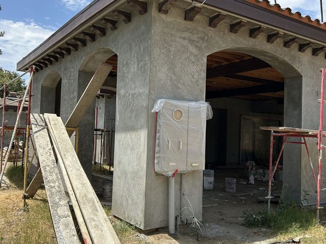 New construction, arched entry in brown coat