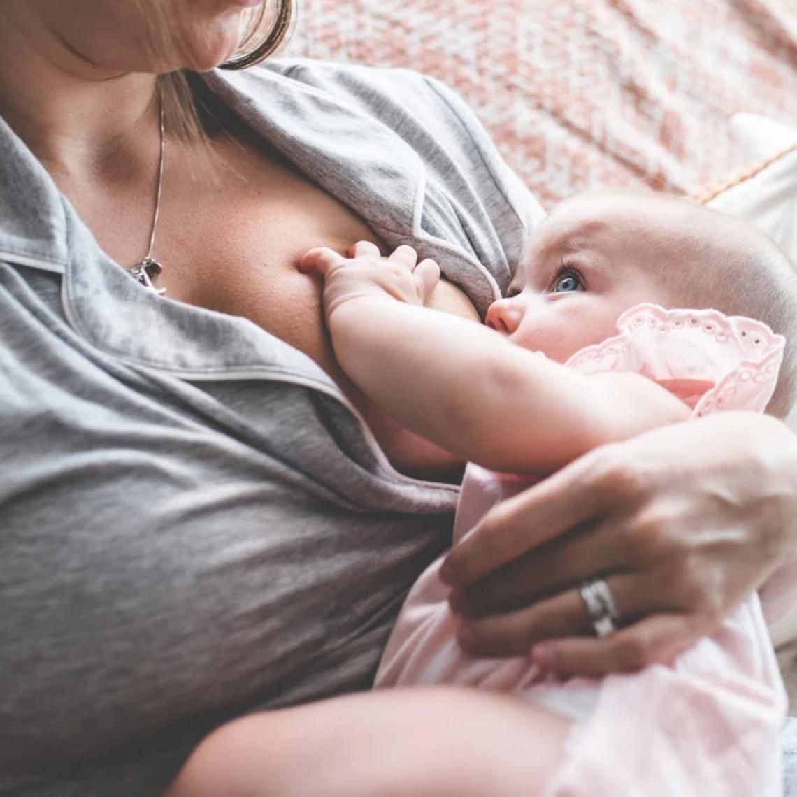 A baby breasfeeding from her mother