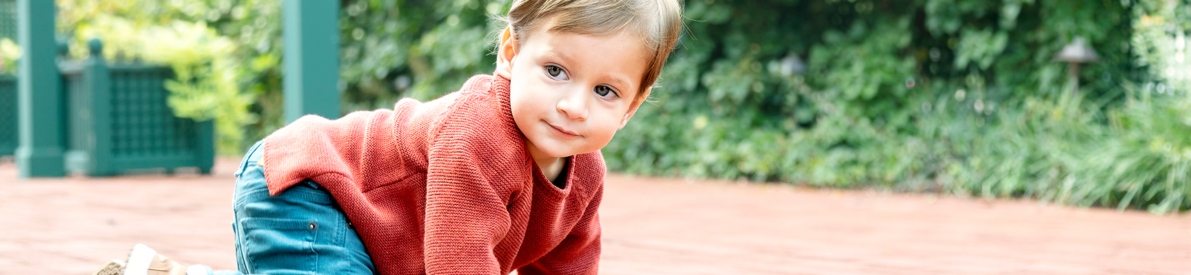 Image of a young boy crawling on the ground.