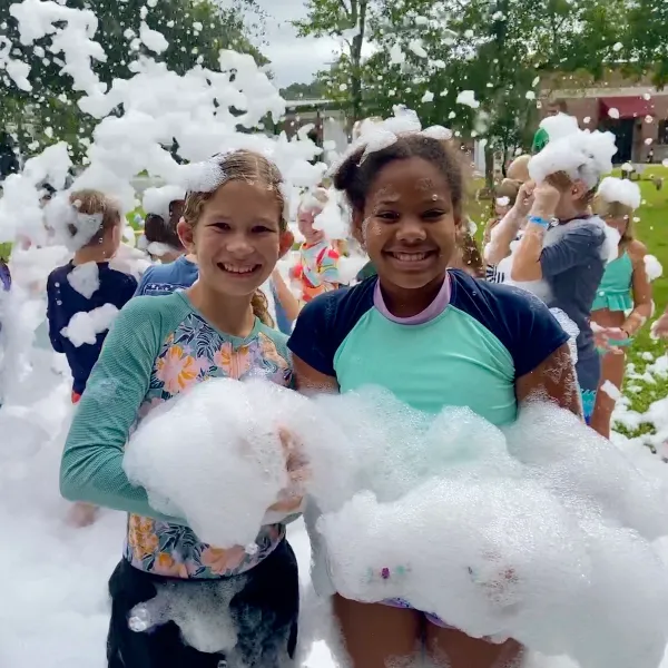 Two girls smiling at a foam party birthday in Tampa Bay Florida