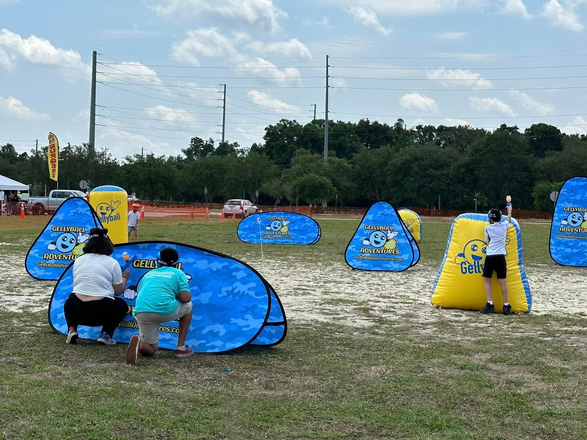 Players take cover behind pop-up bunkers on a large open field