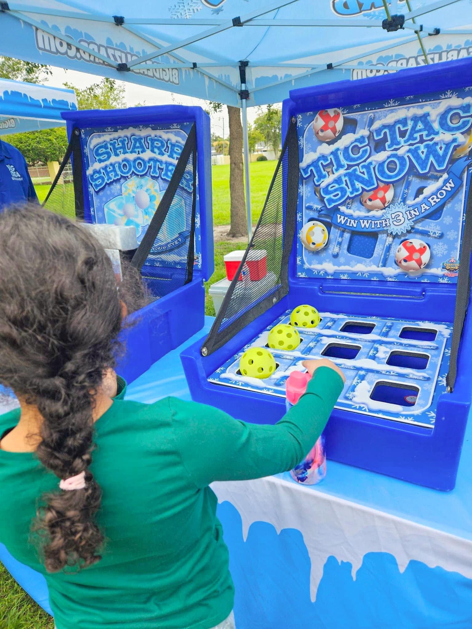 A girl plays Tic Tac Snow under a Big Idea Blizzard tent
