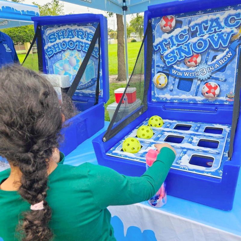 A girl plays Tic Tac Snow under a Big Idea Blizzard tent