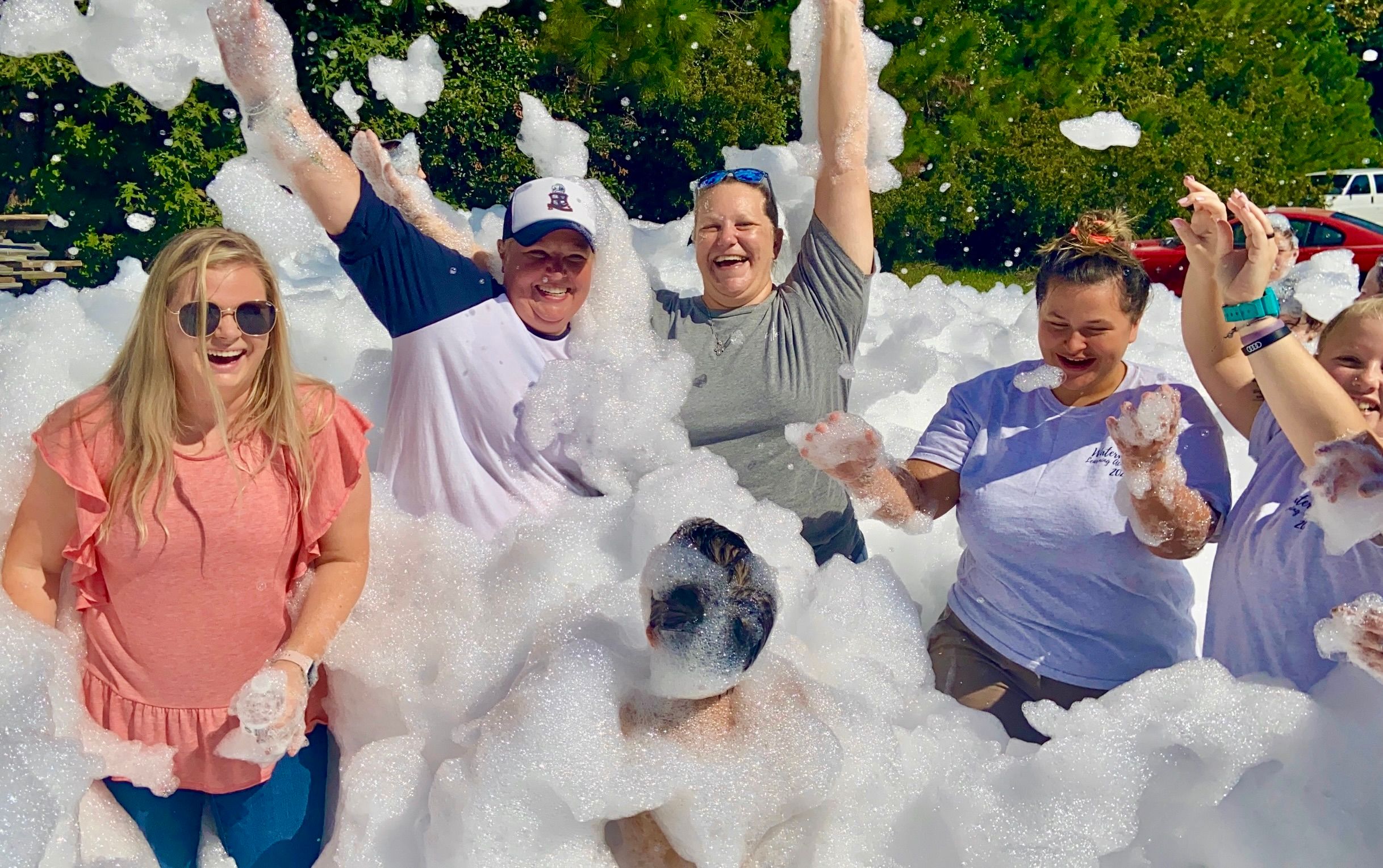 Workers celebrate at a corporate foam event