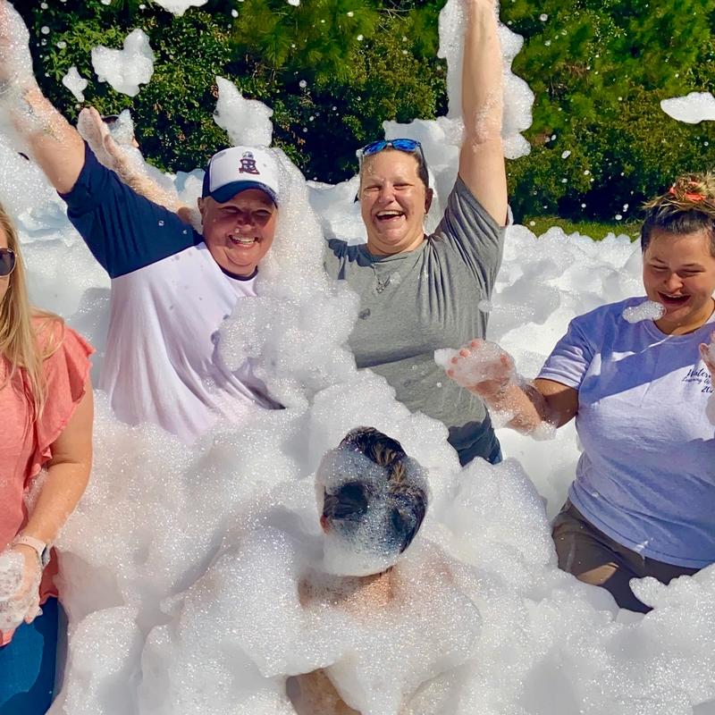 Workers celebrate at a corporate foam event