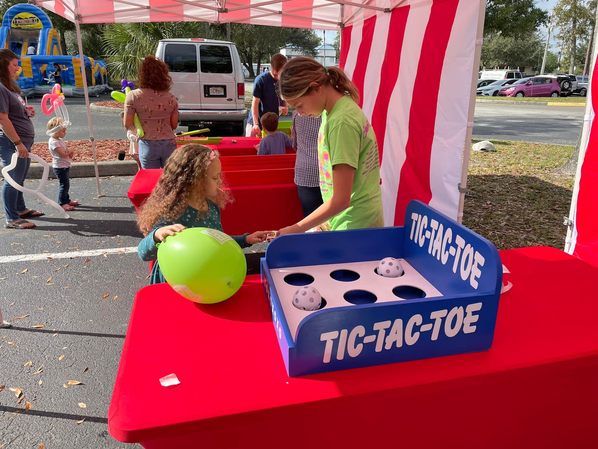 little kids playing the classic carnival game tic-tac-toe at a birthday party