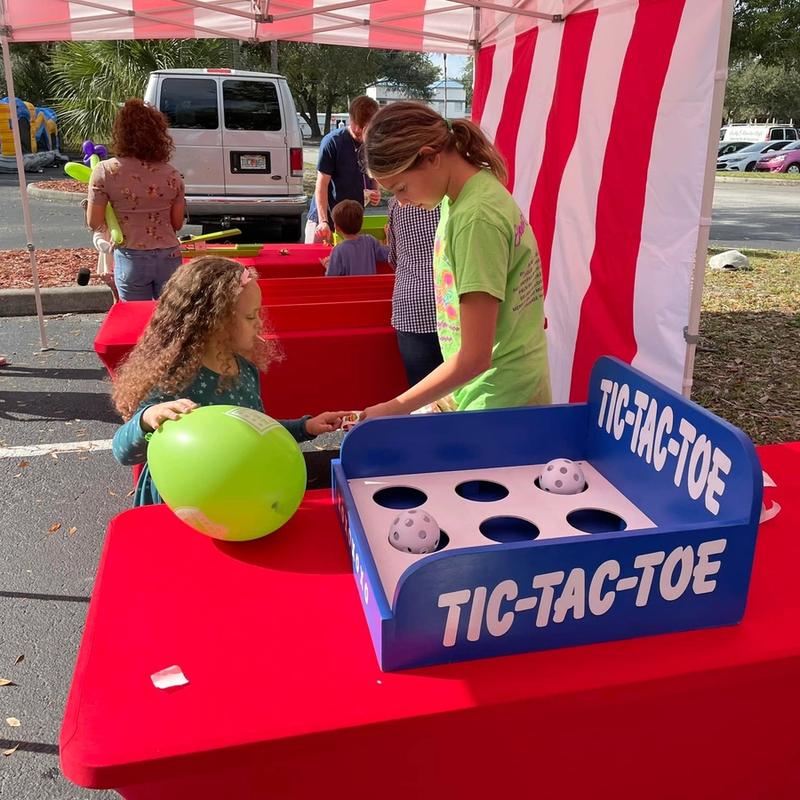 little kids playing the classic carnival game tic-tac-toe at a birthday party