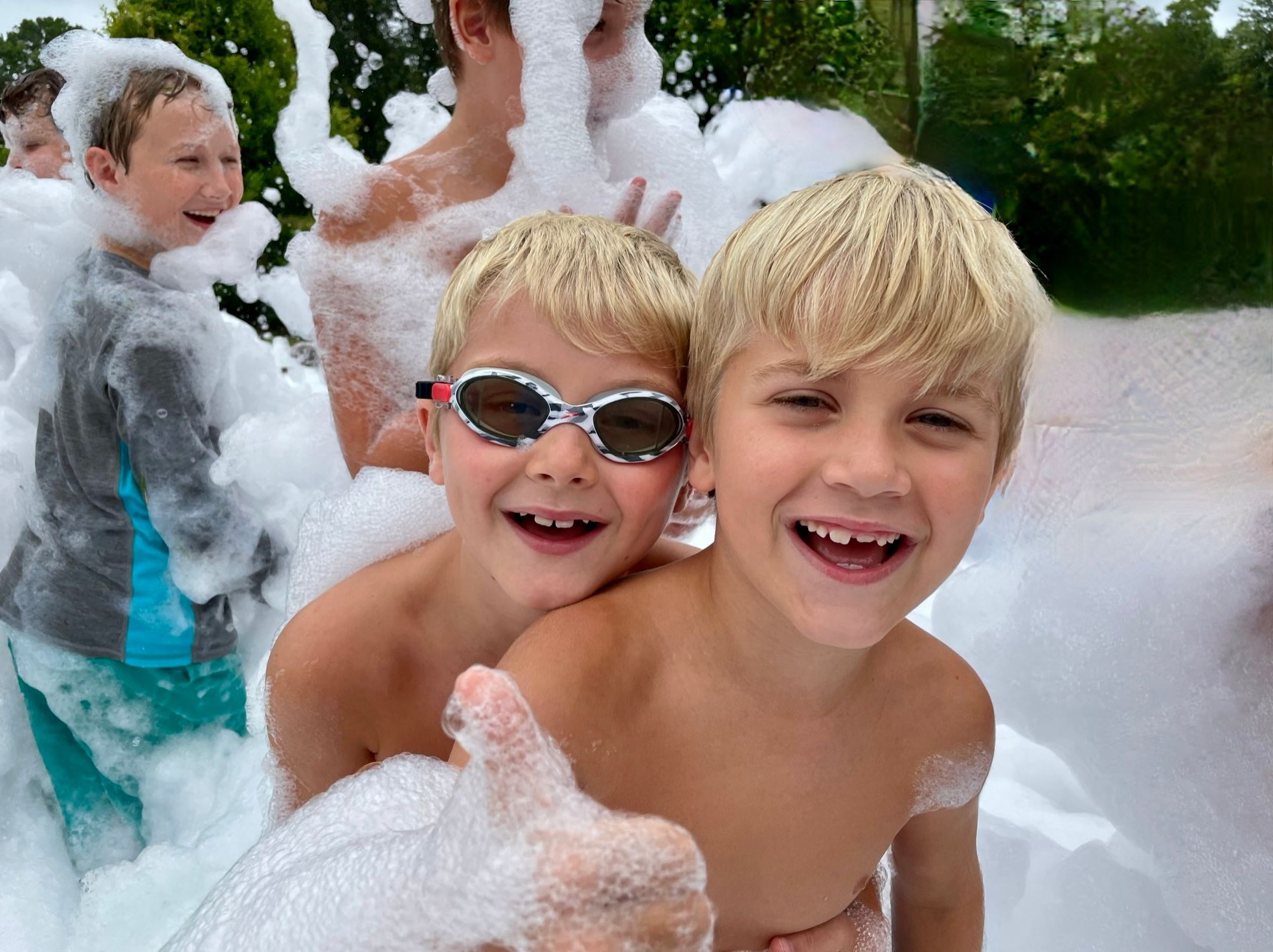 Two kids smiling and laughing at a foam party in Orlando Florida