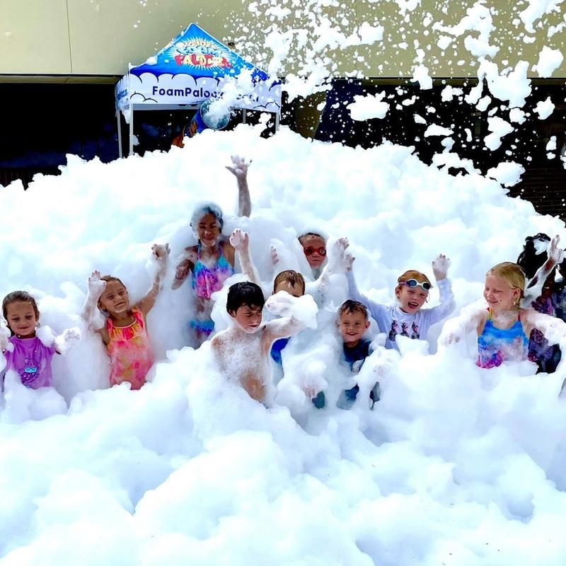 Kids in foam at an end of the year field day.