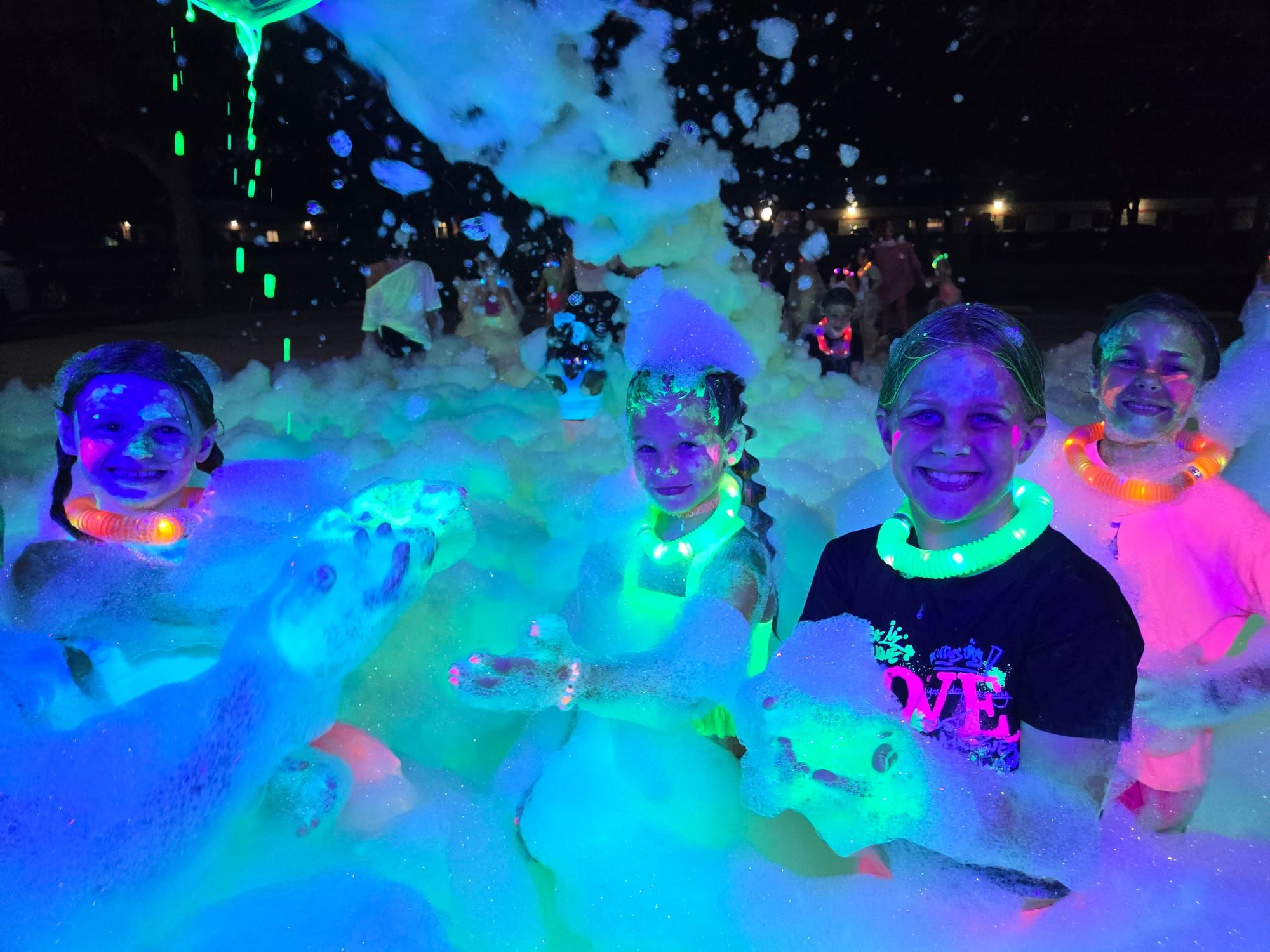kids at a glow in the dark foam party