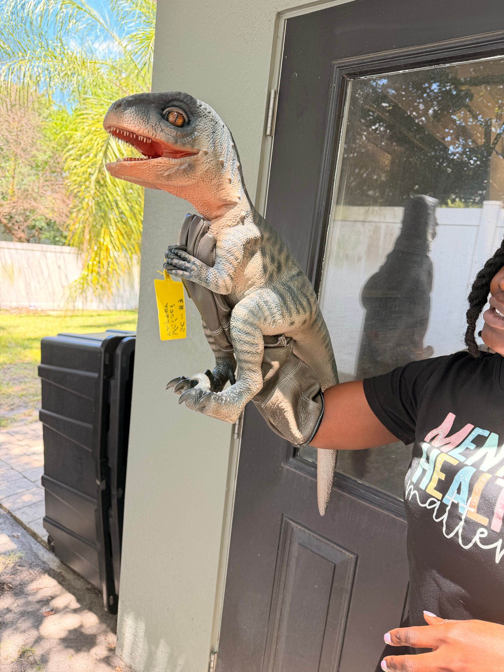 A lifelike baby velociraptor shows its teeth