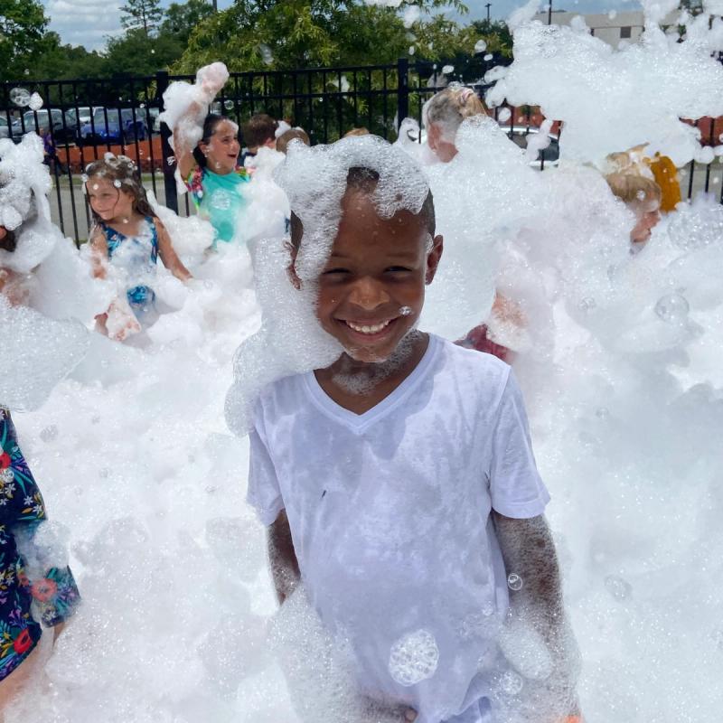 kid smiling in foam at a birthday party