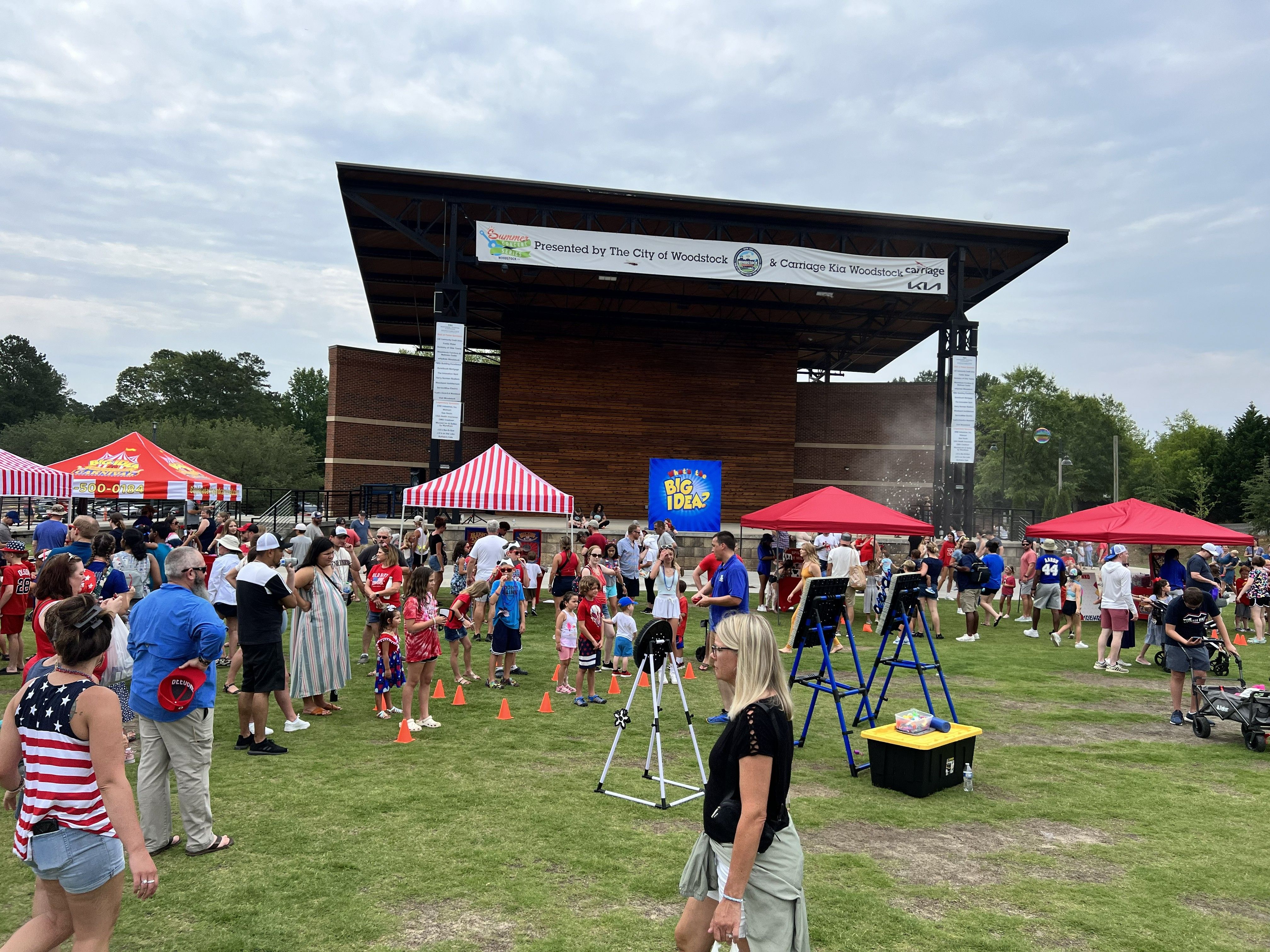 Large community festival with several carnival games and tents.