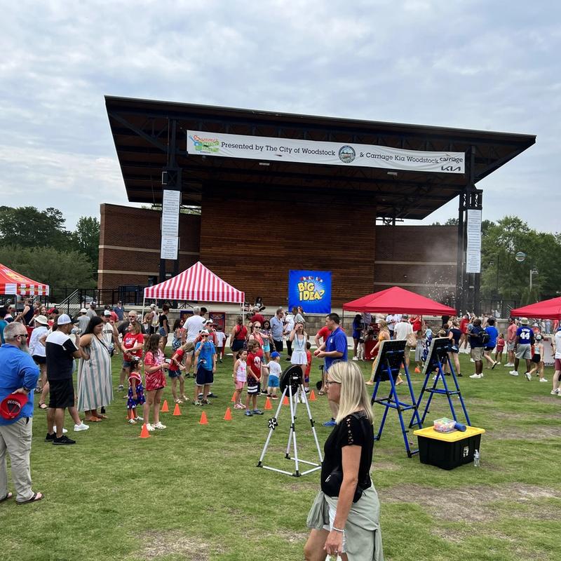 classic carnival games and red and white striped tents setup for a large community festival