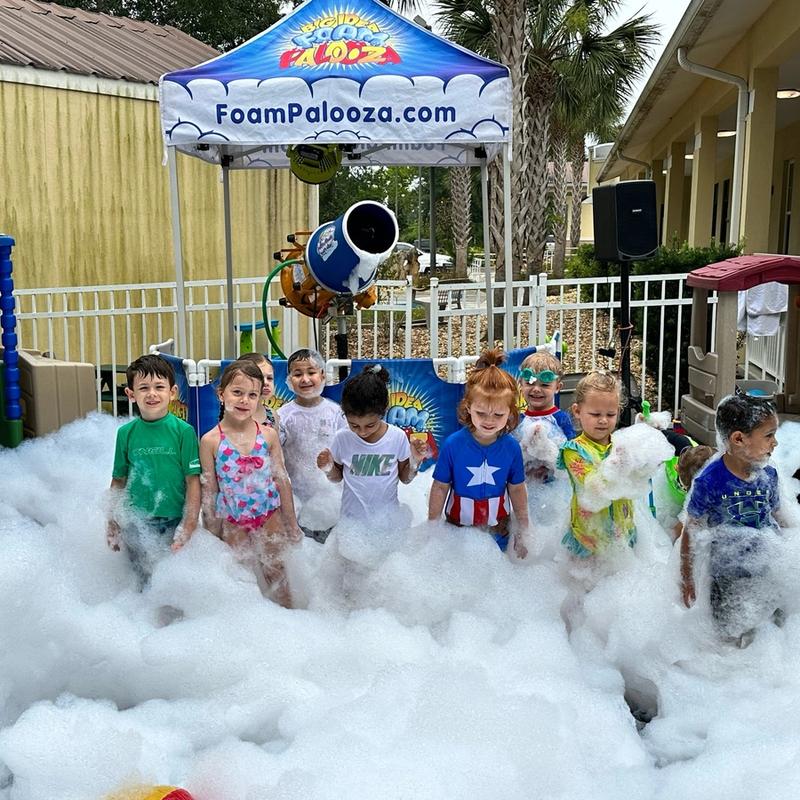 Kids at a backyard birthday foam party