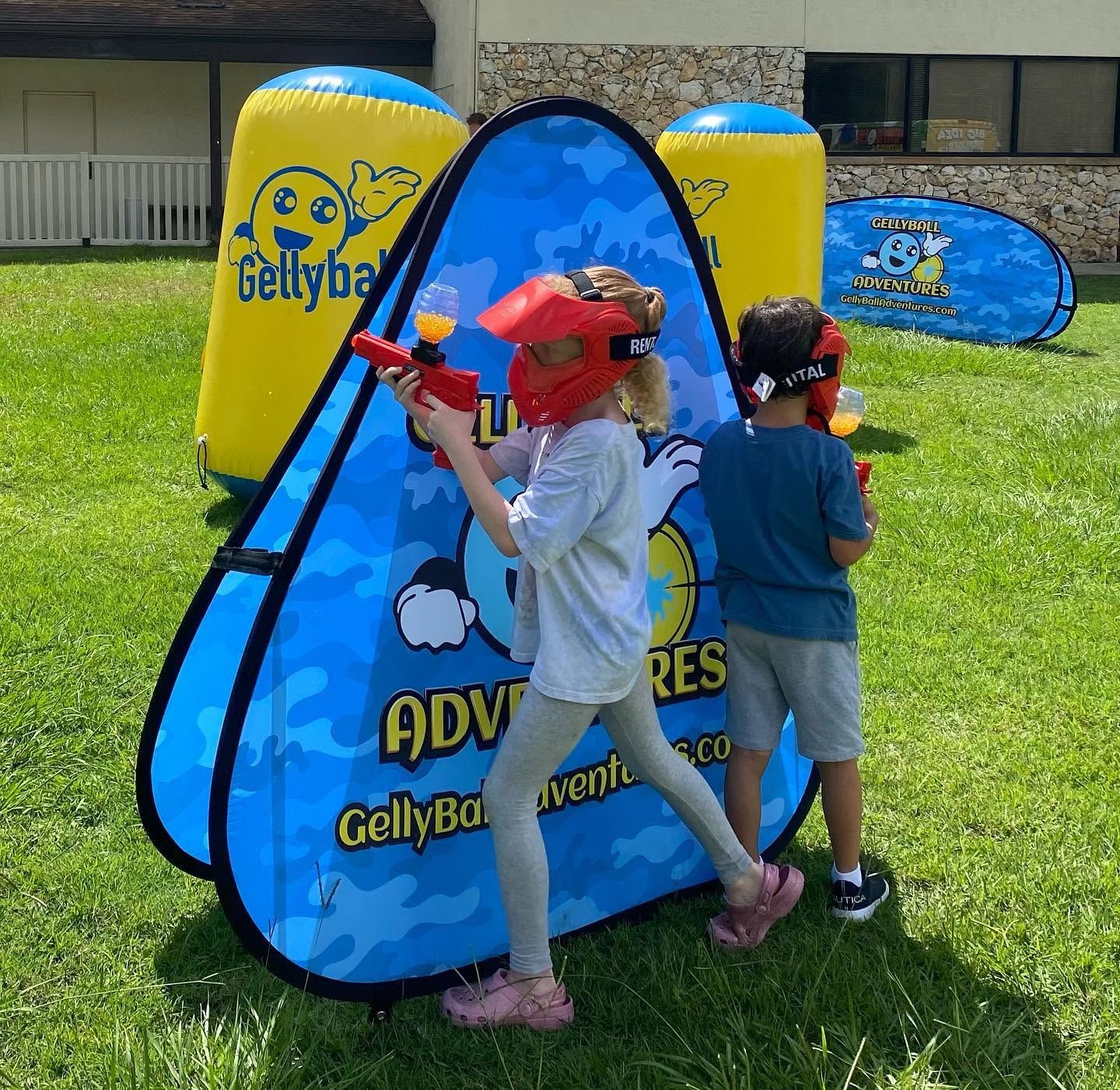 Two kids in masks move along a pop-up bunker