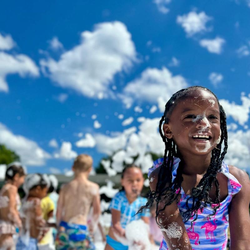 school kids at a field day foam party
