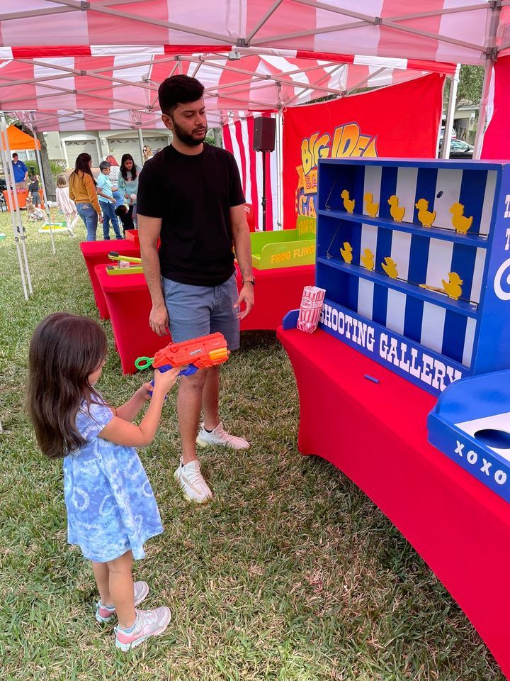 kids under a tent playing classic carnival games at a birthday party