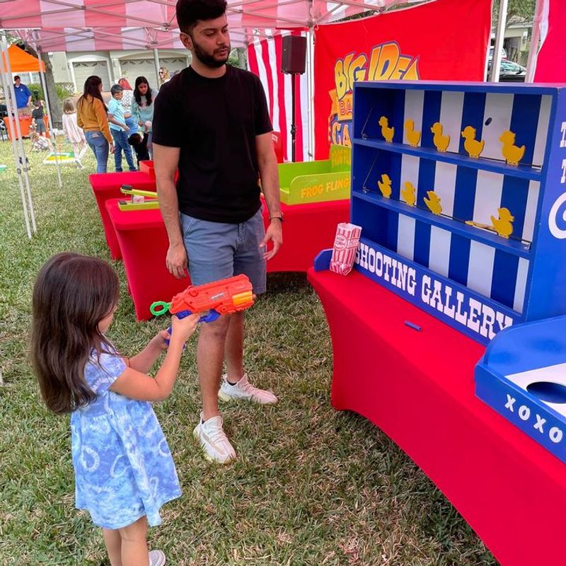kids under a tent playing classic carnival games at a birthday party