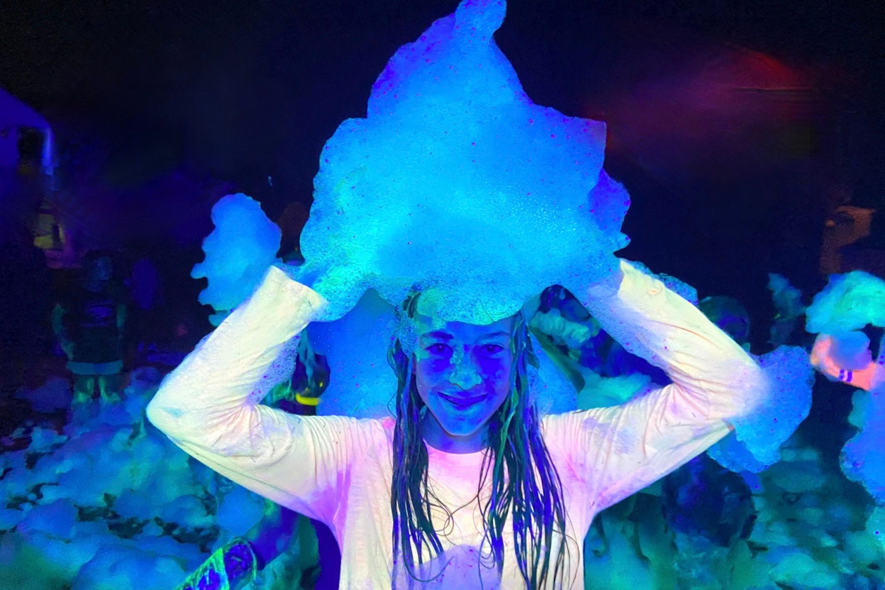 Girl at a glow foam party in Fort Myers Florida with foam on her head