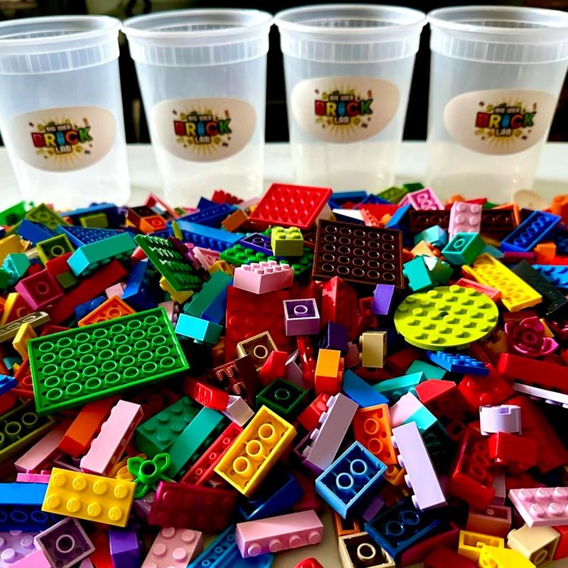 A heap of colorful building bricks in front of a row of Brick Lab cups