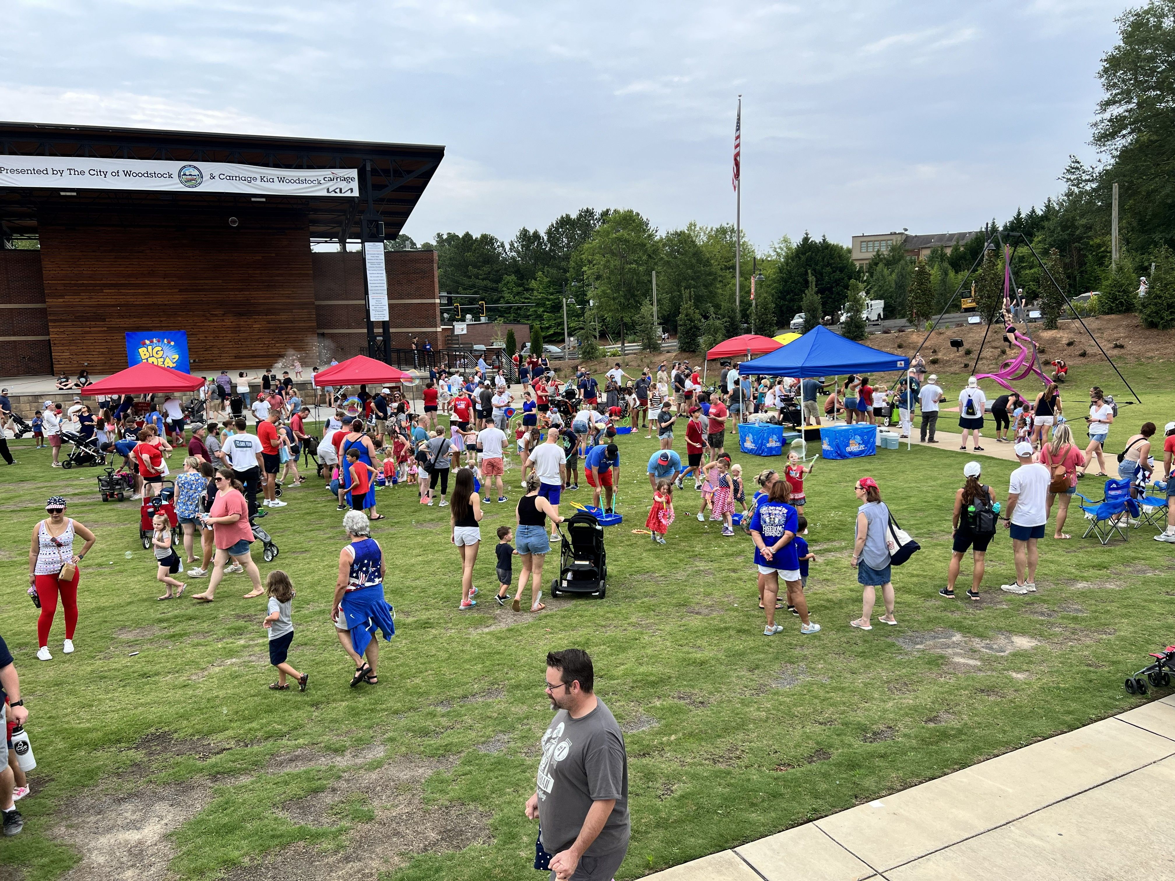 a large crowd of kids and parents at a community carnival event.