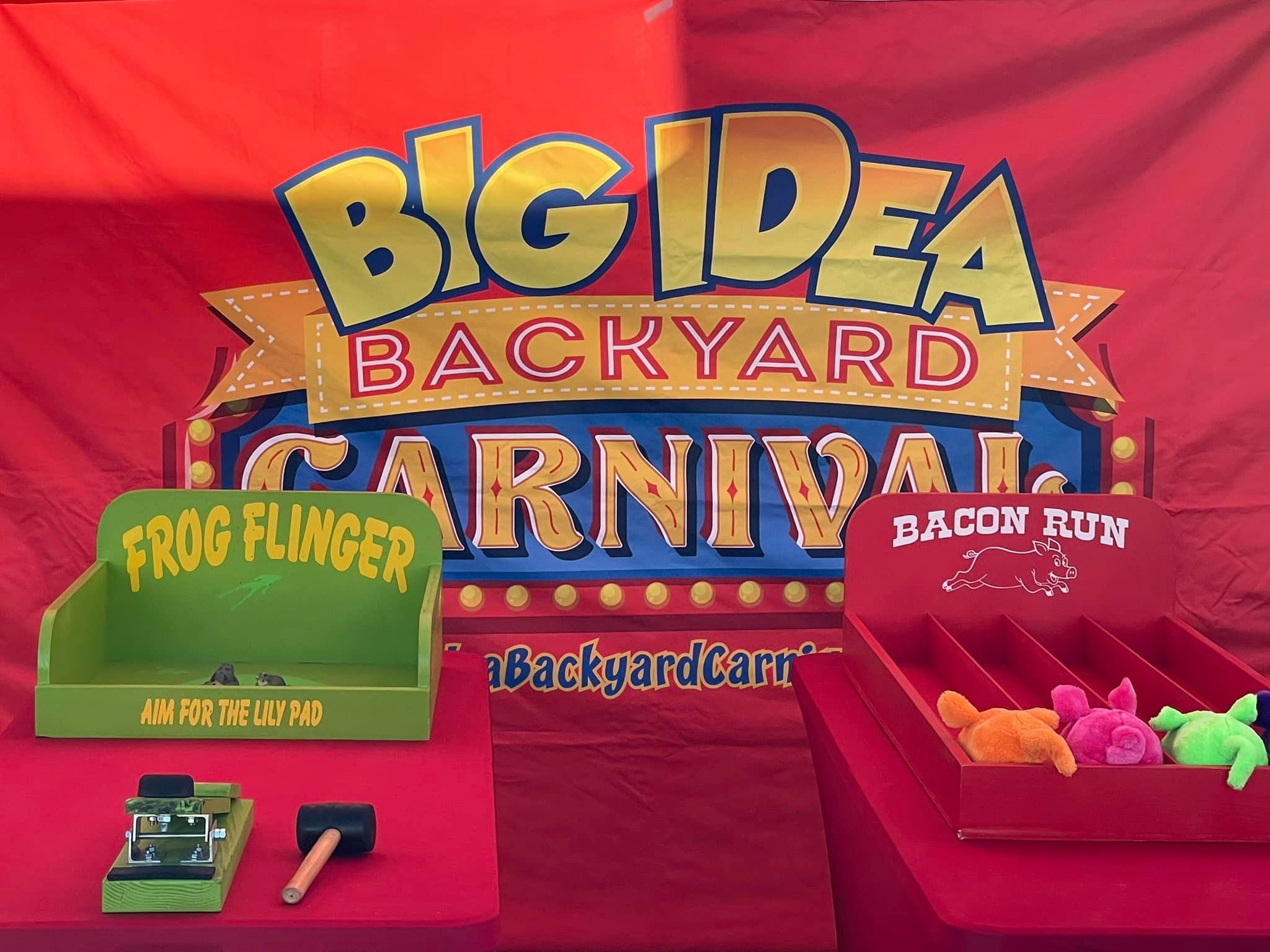 Carnival games setup at an event in Atlanta in front of a themed backdrop.
