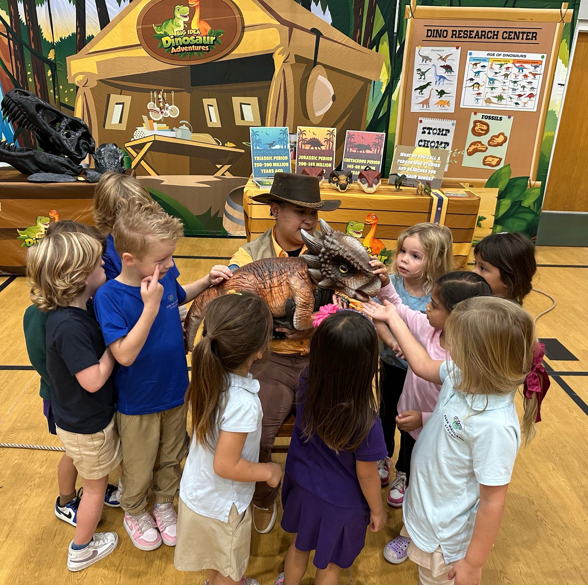 A group of kids gathers with a trainer at the Dino Research Center