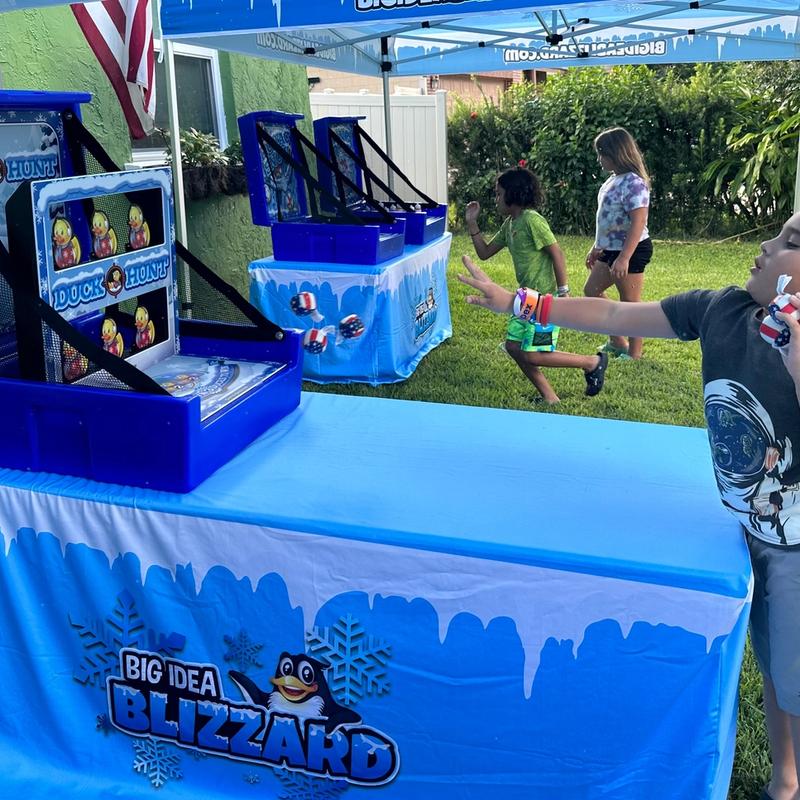 A boy plays Duck Hunt at a table dressed in the Blizzard penguin cover