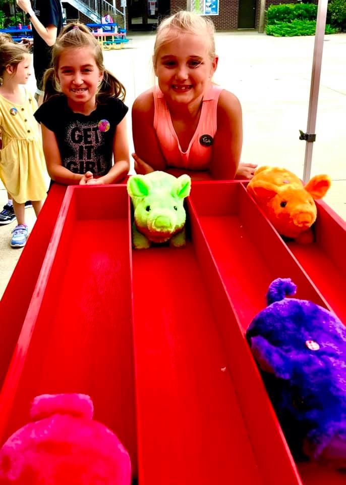 kids smiling at the bacon run carnival game at a birthday event