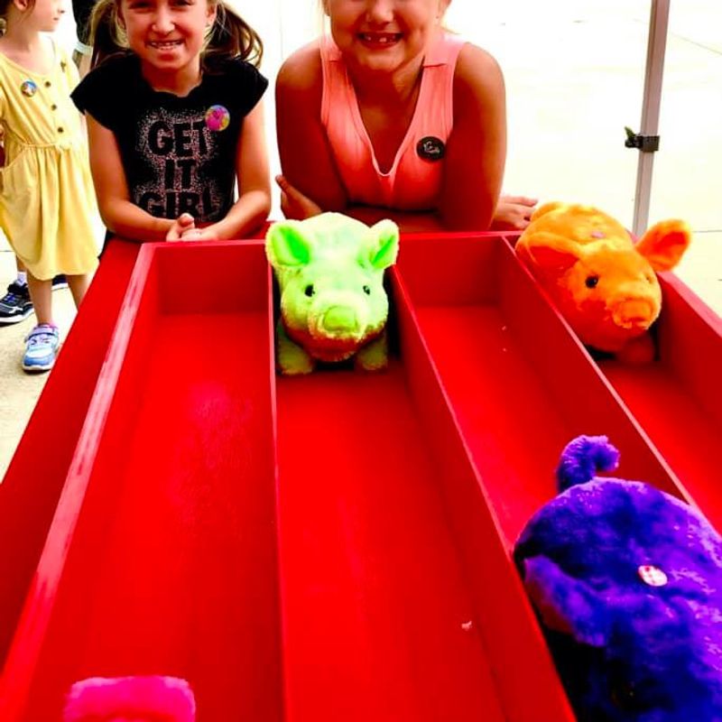kids smiling at the bacon run carnival game at a birthday event