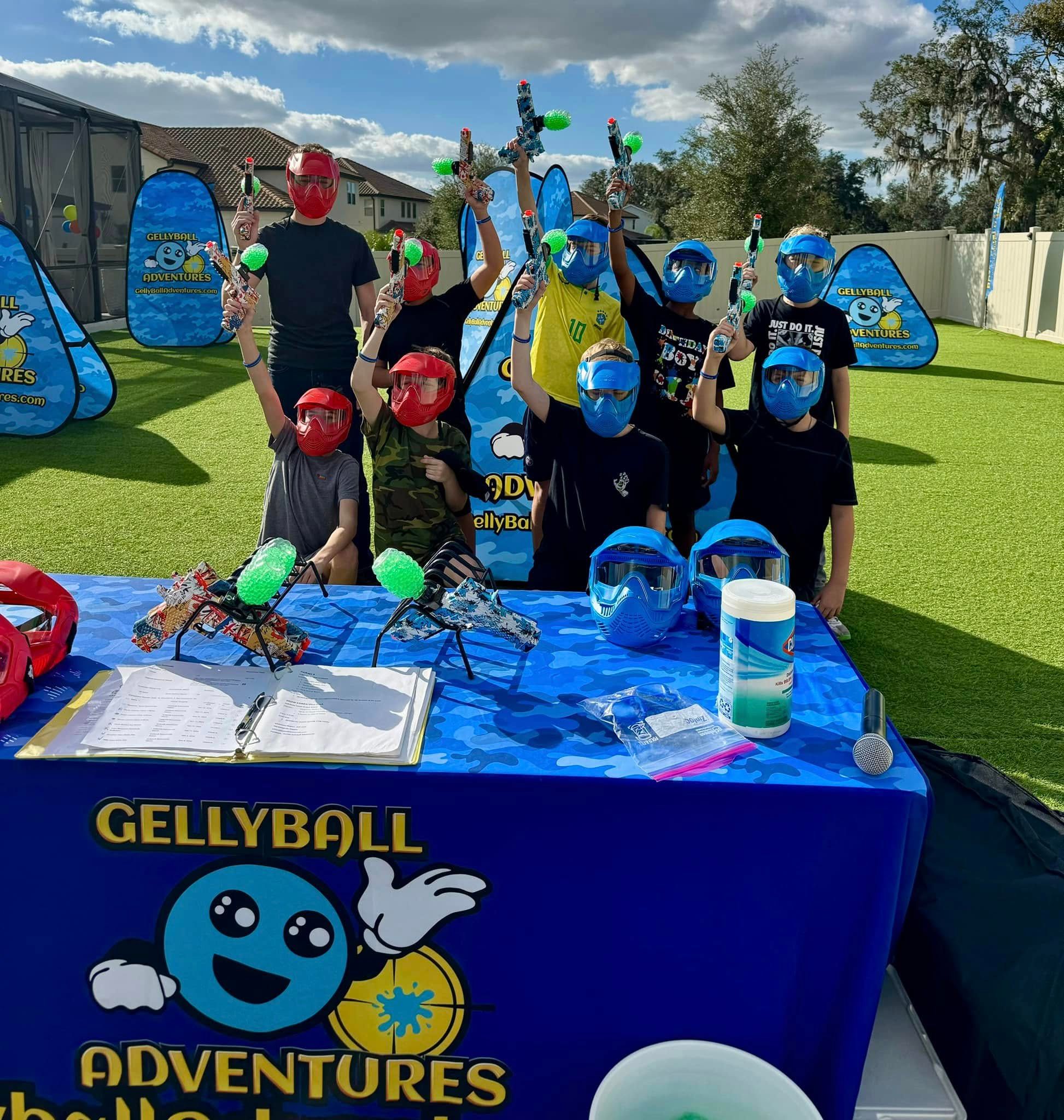 Kids raise their gel blasters behind the check-in table