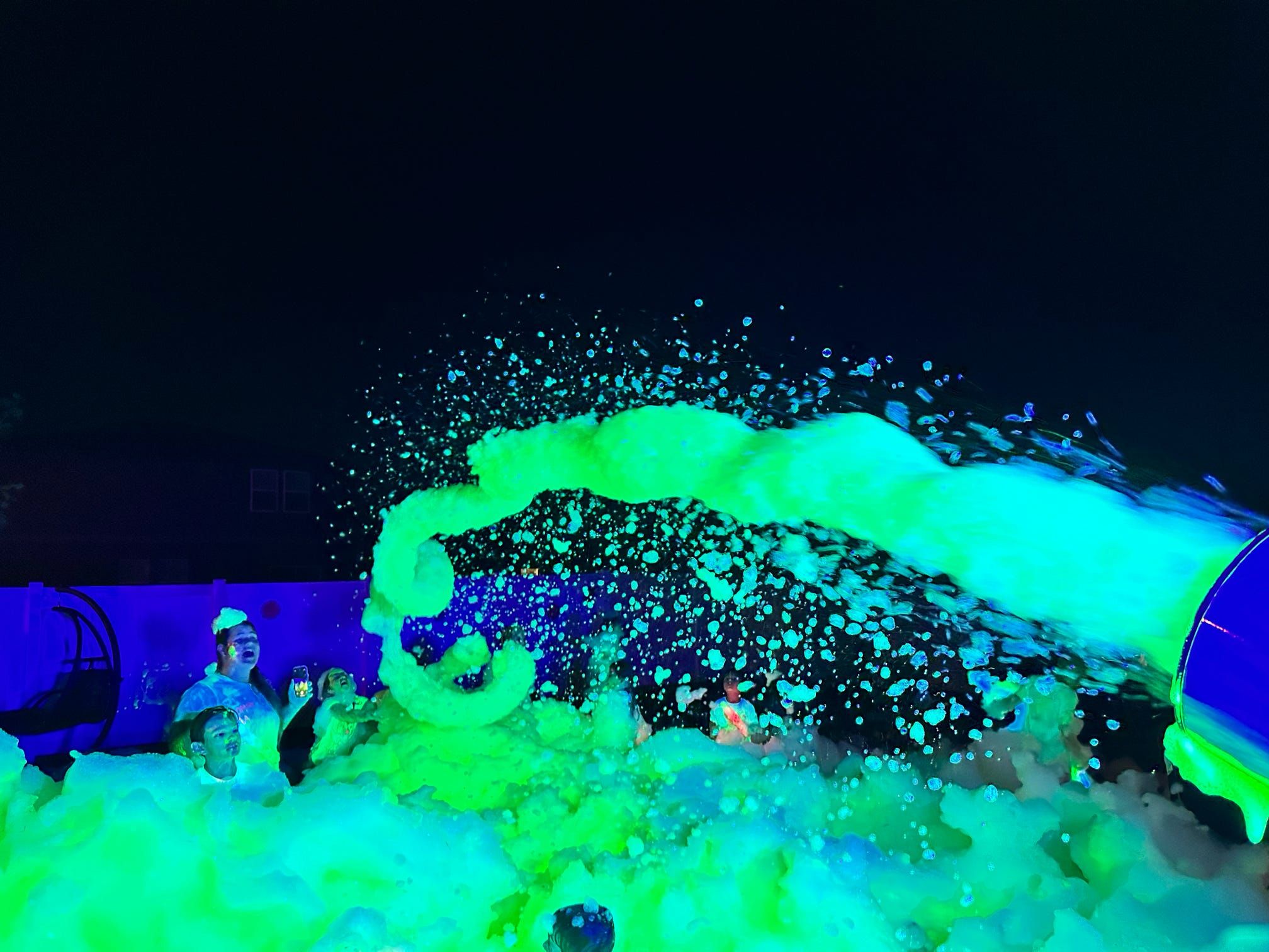 Foam cannon shooting UV foam at a party