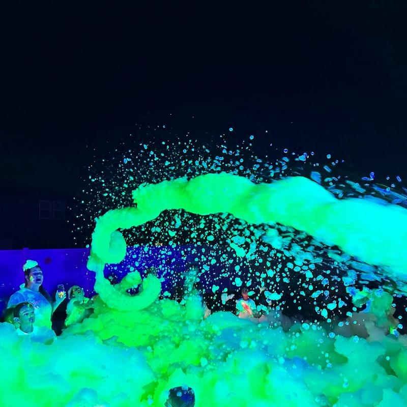 Foam cannon shooting UV foam at a party