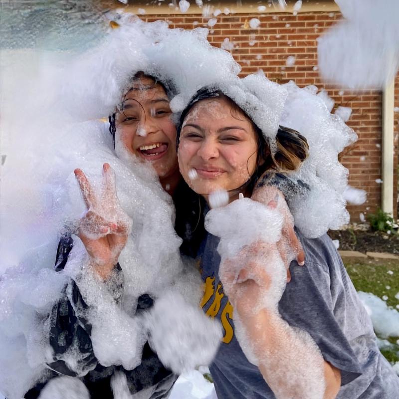 Two workers at a corporate foam party