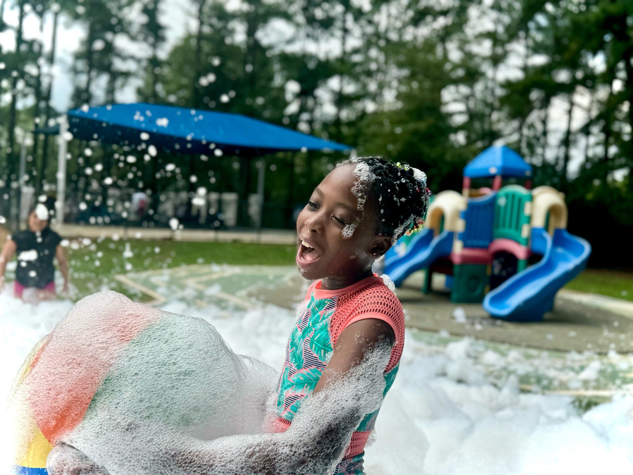 Kids playing with beach balls at a foam party in Woodstock