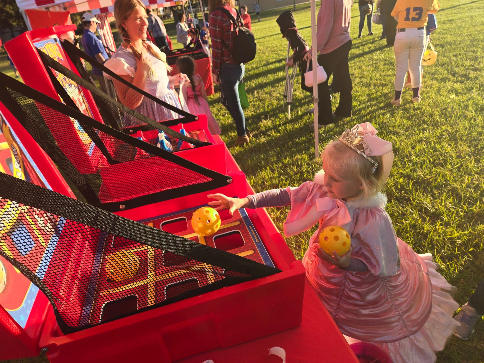 Kids in costume playing tic-tac-toe at an Orlando carnival event.