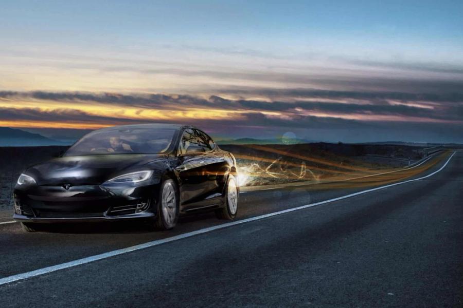 Car driving along empty road