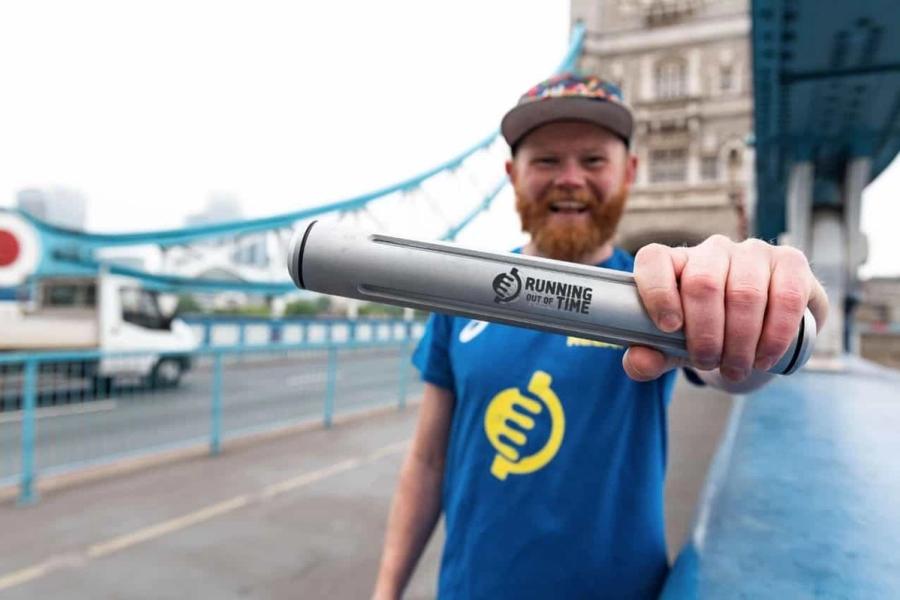 Man holding baton that say Running Out Of Time