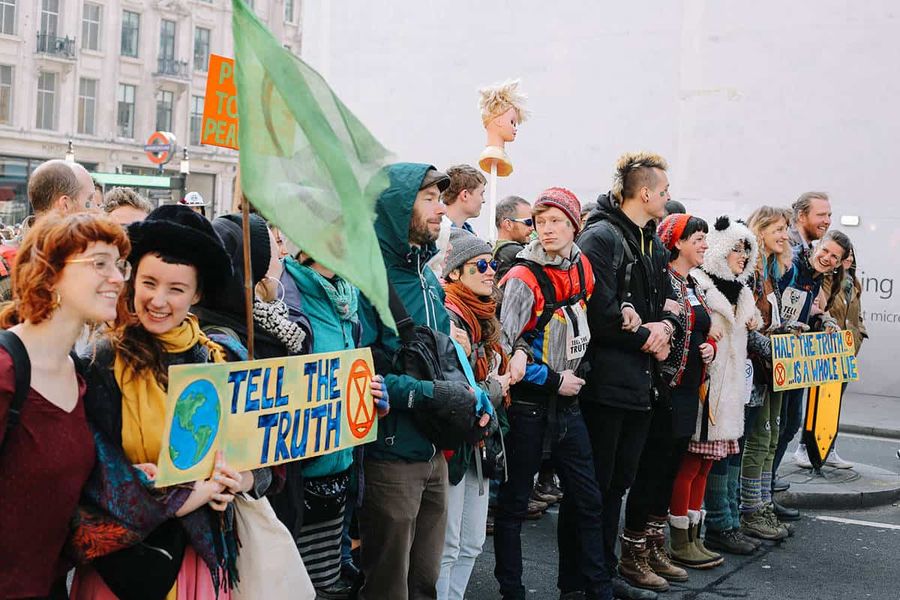 People lining up for the International Rebellion, holding placards and banners.