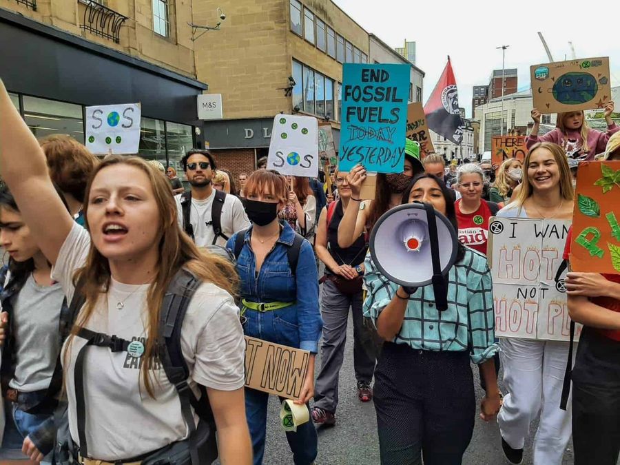 A crowd of protestors, one is holding a megaphone.