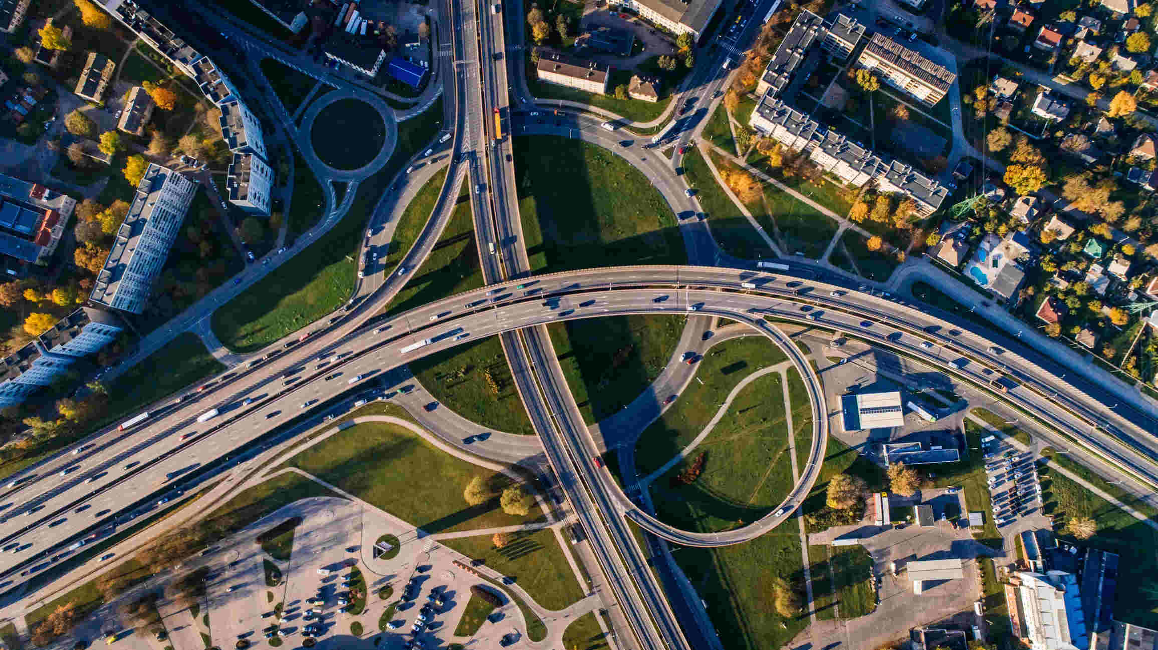 Aerial photo of multiple highways above a green park.